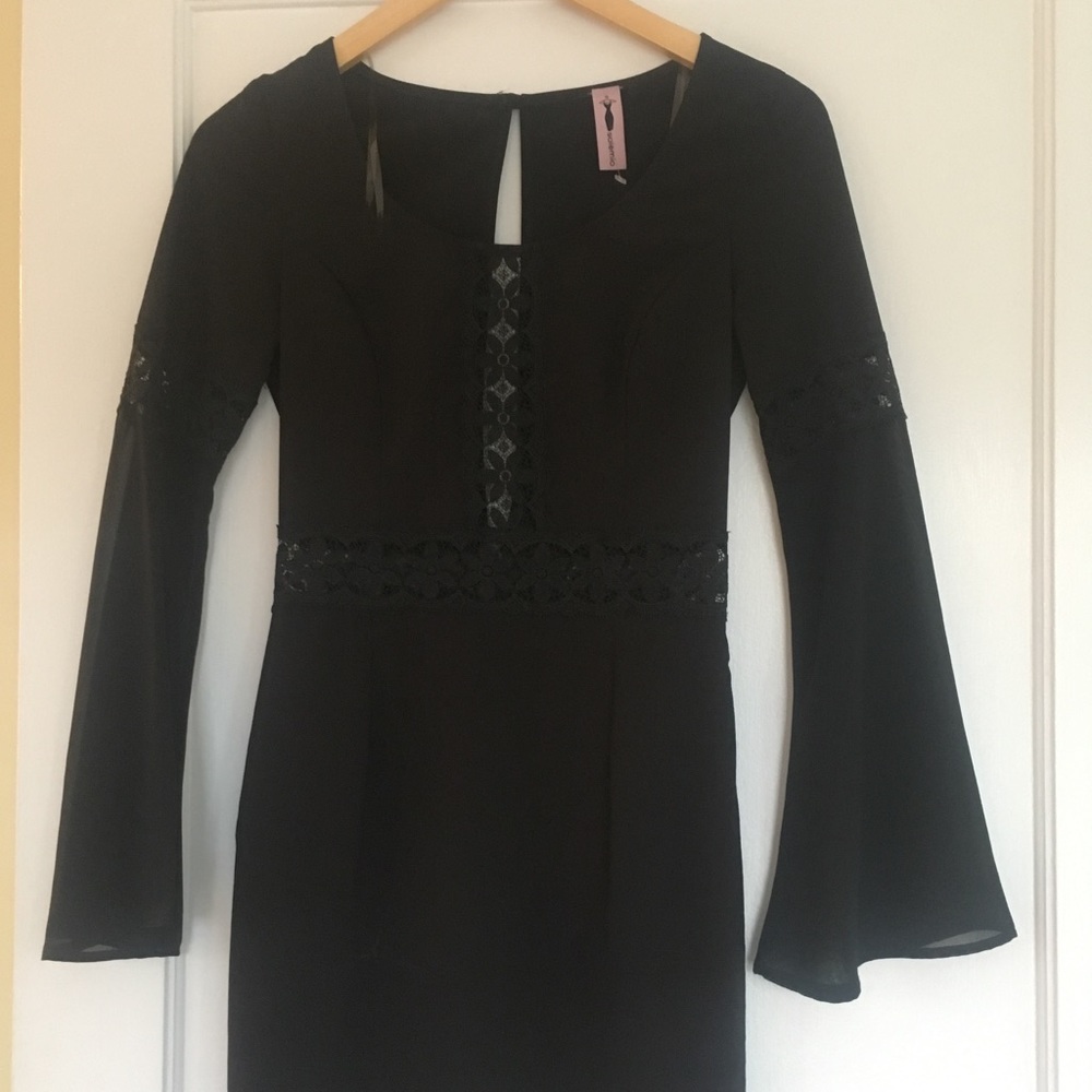 a chic/sheer black dress with ornate design.